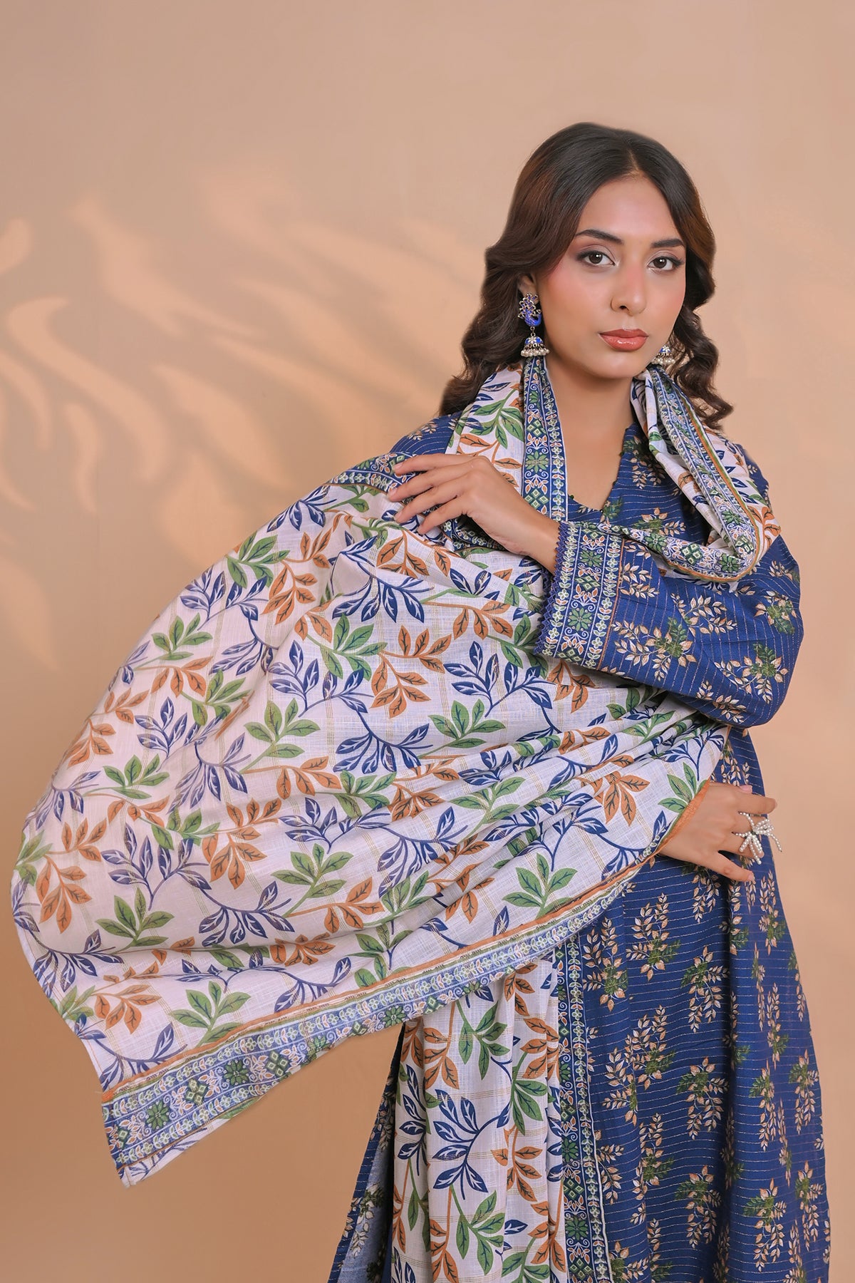 Close-up of micro-leaf floral print on royal blue unstitched khaddar suit