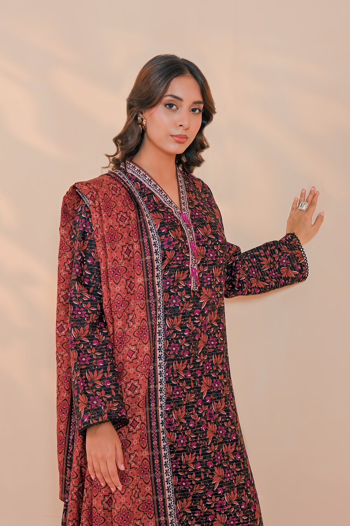 Close-up of brown botanical sprig print on blush pink unstitched khaddar suit