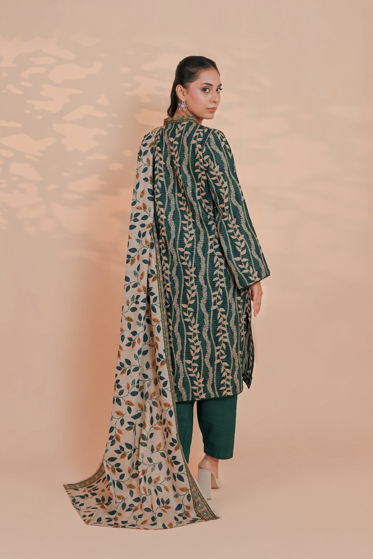 Close-up of botanical vine print on pine green unstitched khaddar suit