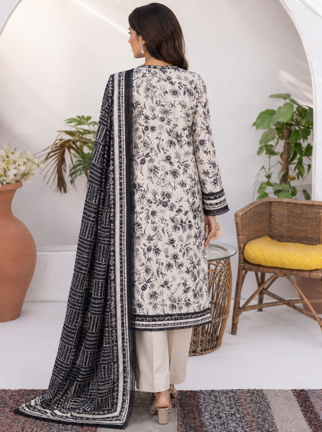 Unstitched off-white Pakistani lawn suit with black botanical vine print